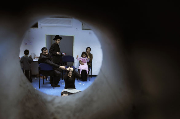 Gallery Gaza:  Israelis sit in a bomb shelter in the southern city of Ashkelon