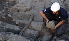 An archaeologist holds a cannonball of a Spanish galleon at a Buenos Aires building site.