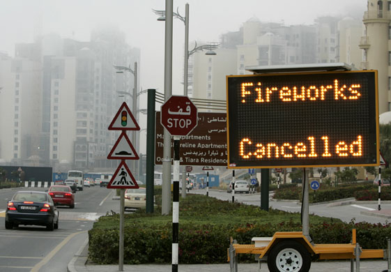 Gallery New Year: Dubai, United Arab Emirates: Cars pass a sign at Jumairah Palm Island