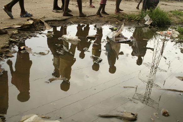 Gallery Zimbabwe cholera: Children walk past rain water and sewage near Harare