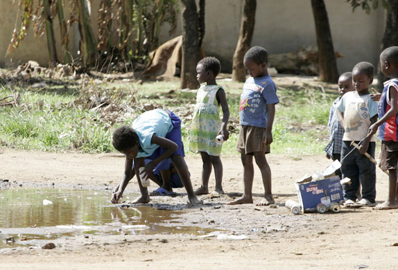 Gallery Zimbabwe cholera: Children play with stagnant raw sewage at the Machipisa suburb in Harare