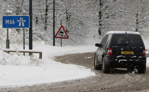 Gallery December snow: A car on the slip road to the M66 motorway in Ramsbottom