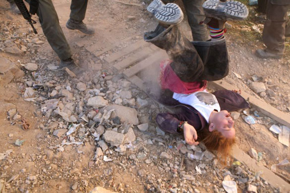 Gallery Hebron: A Jewish settler falls on the ground