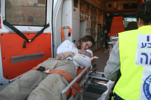 Gallery Hebron: An injured settler is taken into an ambulance