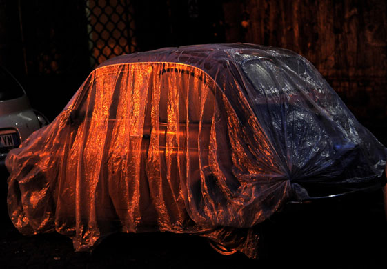 Gallery 24 hours in pictures: A plastic cover protects an old Fiat Cinquecento