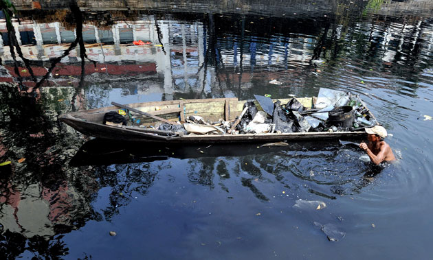 Gallery River Citarum : A scavenger collects valuable items from the river  Citarum in Jakarta 