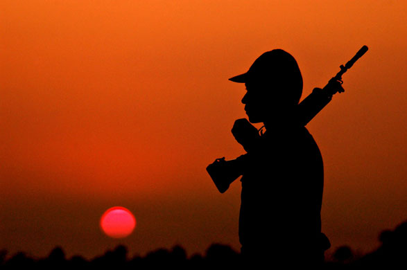 Gallery 24 hours in pictures: An Indian Border Security Force soldier stands guard 