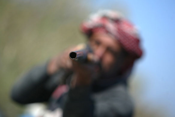 Gallery 24 hours in pictures: An Iraqi Marsh Arab points his rifle 
