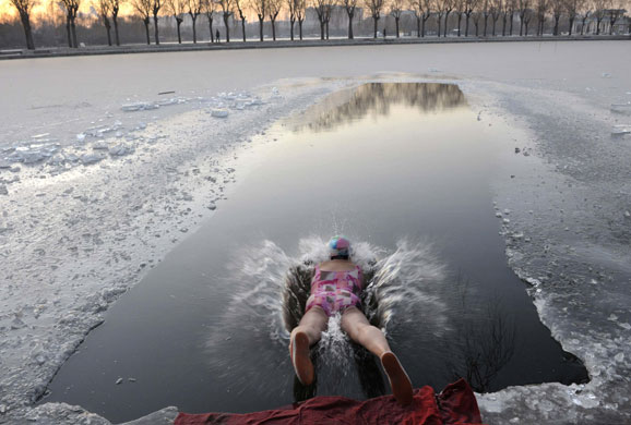 Gallery 24 hours in pictures: A winter swimmer jumps into icy water