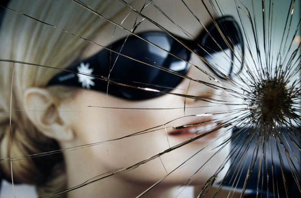 Gallery 24 hours in pictures: A poster behind a smashed shop window in Athens