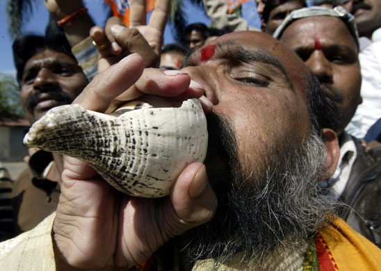 Gallery 24 hours in pictures: A supporter of BJP blows a conch in Bhopal