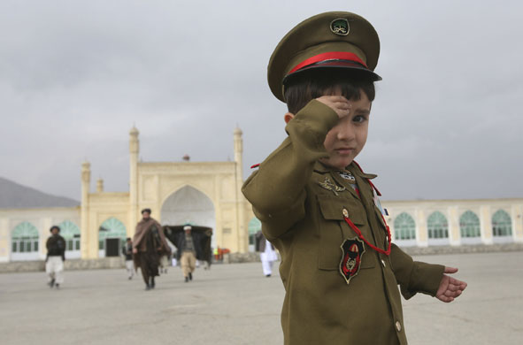 Gallery 24 hours in pictures: Afghan child, salutes after offering the prayers of Eid al-Adha festival  