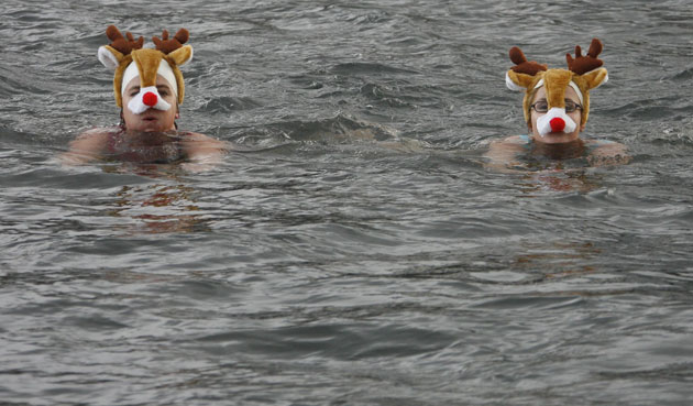 Gallery 24 hours in pictures: People wearing a Reindeer hats swim across the Limmat river in Zurich