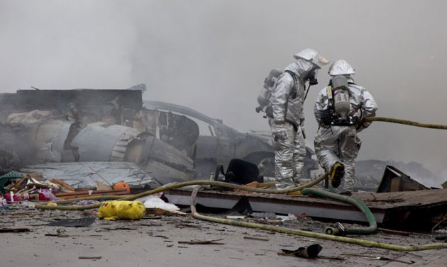 Gallery December 9 2008: Firefighters look near the remains of a military jet