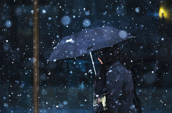 Gallery December 9 2008: Toronto, Canada: A woman walks through a light snowfall