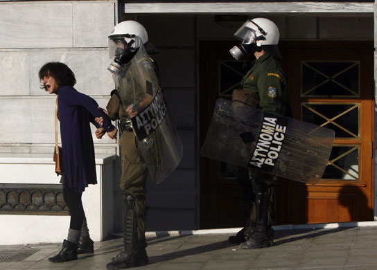 Gallery Funeral in Athens: Riot police arrest a woman during clashes in Athens