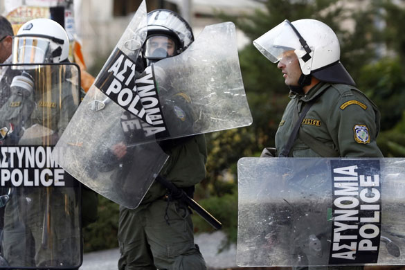 Gallery Funeral in Athens: A riot police officer holds his broken shield in Athens  