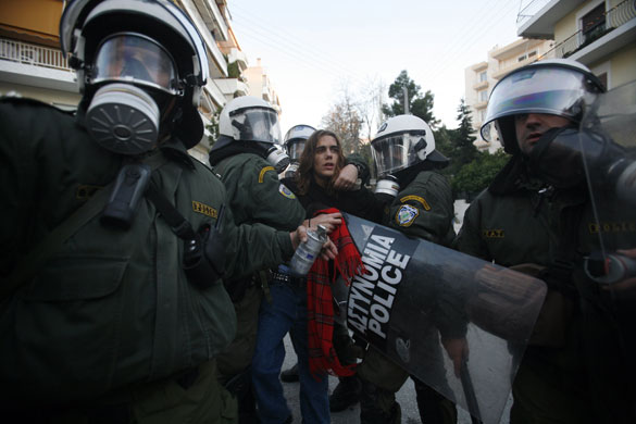 Gallery Funeral in Athens: Riot police officers arrest a young boy near the funeral of Grigoropoulos
