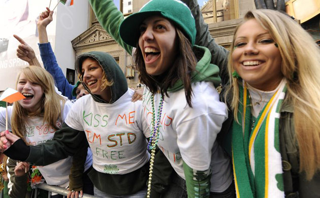 A group of women wave Irish flags during the St Patrick's Day parade in New  York