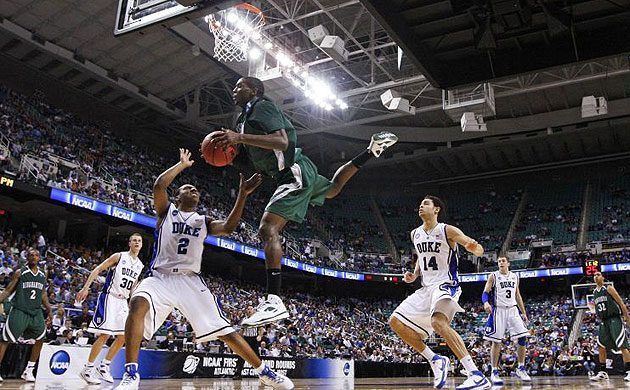 Binghamton University forward DJ Rivera (2) jumps up against Duke University guard Nolan Smith during the first round of the NCAA college basketball tournament in Greensboro, North Carolina.