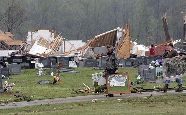 Members of the Corinth Baptist church of Magee, Mississippi, salvage paintings following an early morning tornado 
