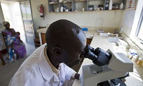 Elias Oluja, lab technician from Tiriri health centre tests patients for HIV during his weekly visit to the lab at the Ojom health centre, Katine