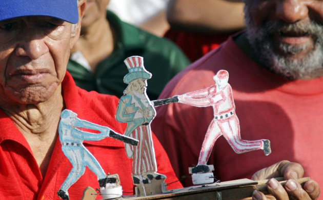 Young Cubans wave flags during a May Day parade on Havana's Revolution Square 