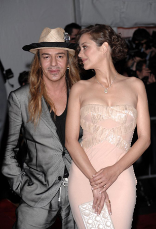Oscar award winning actor Marion Cotillard stands with designer John Galliano at the  Metropolitan Museum of Art's costume institute gala in New York 