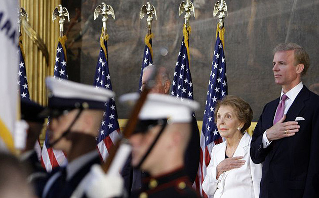 Former first lady Nancy Reagan, second from right, and Frederick J. Ryan Jr., chairman of the Ronald Reagan Presidential Foundation, right, put their hands over they hearts as the National Anthem is played in the Capitol Rotunda in Washington, Wednesday, June 3, 2009, during a ceremony to unveil a bronze statue of President Ronald Reagan. 