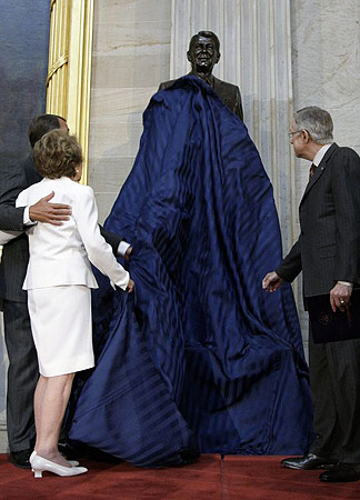  Former First Lady Nancy Reagan, accompanied by House Minority Leader John Boehner of Ohio, left, and Senate Majority Leader Harry Reid of Nev., pulls the covering off of the Ronald Reagan statue, Wednesday, June 3, 2009, in the Rotunda of the Capitol in Washington.