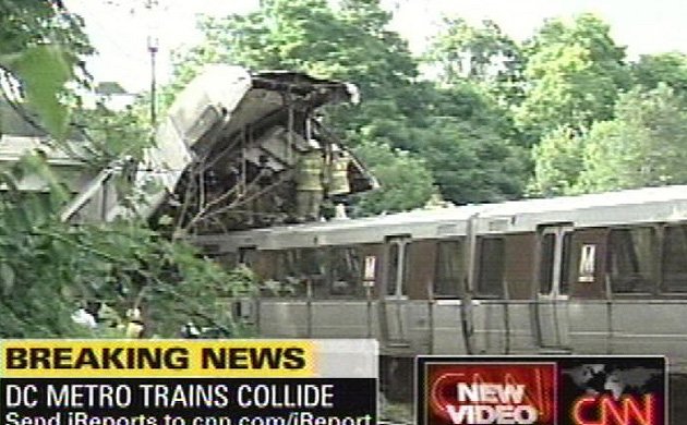 Firefighters investigate the scene of a collision between two Metro transit trains in north-east Washington
