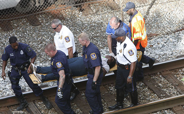 Washington DC emergency workers transport a Metro passenger away the scene of a collision between two trains