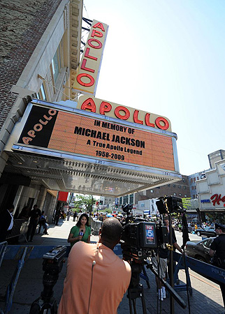 A television news crew reports from the Apollo theatre