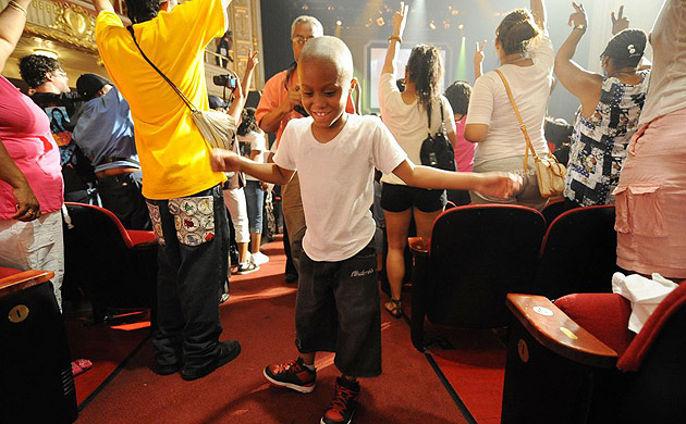 A boy dances in the aisle of Apollo theatre. The legendary venue located in New York's Harlem neighbourhood is where Michael Jackson's career started 