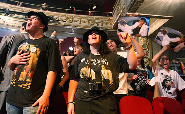 Fans sing during a tribute to Michael Jackson at Apollo theatre