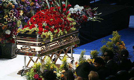 Michael Jackson's body rests inside a golden casket on the stage at the