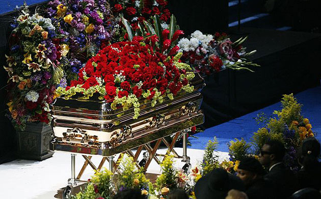 Michael Jackson's body rests inside a golden casket on the stage at the Staples Centre