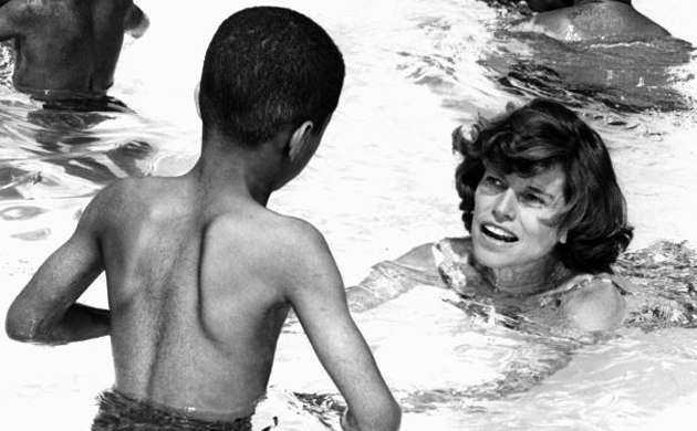 Eunice Kennedy Shriver is shown swimming with youngsters in a pool in 1964
