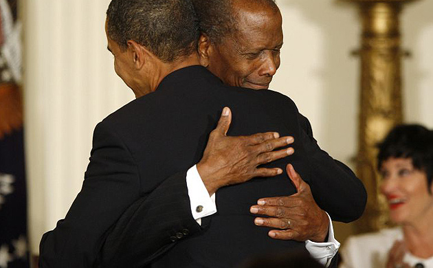 Barack Obama hugs actor Sidney Poitier after presenting him with the presidential medal of freedom at the White House 