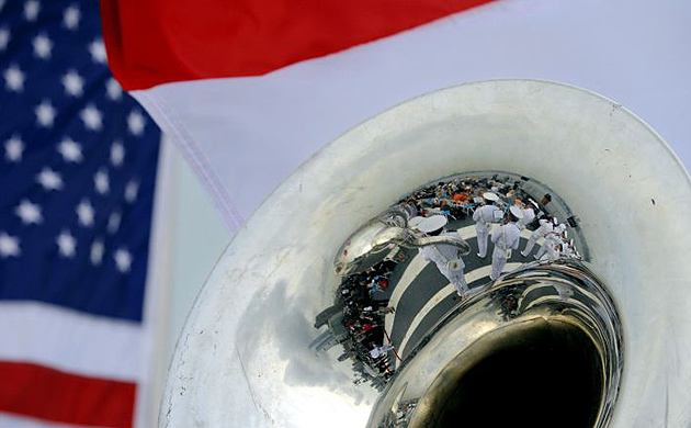 Flags fly as the Dutch naval band is reflected in a tuba during a ceremony celebrating Henry Hudson's voyage up the Hudson River