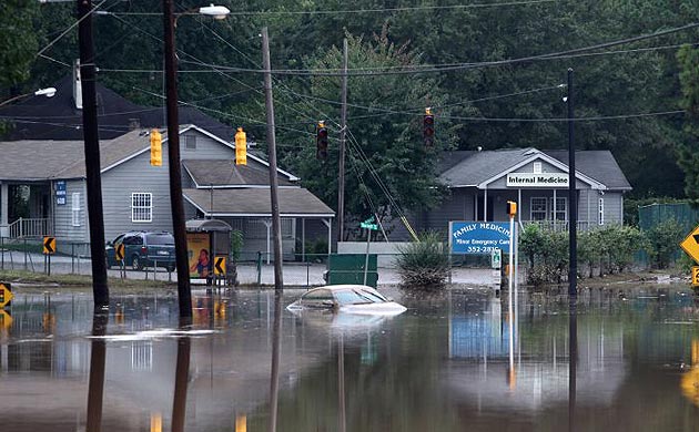 A car sits submerged on a flooded portion of a road in Atlanta, Georgia. Sonny Purdue, Georgia's governor, has declared a state of emergency in 17 counties.