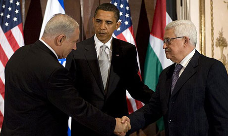 Benjamin Netanyahu, Israel's prime minister, and Palestinian leader Mahmoud Abbas shake hands while Barack Obama looks on at the Waldorf Astoria in New York. Photograph: Jim Watson/AFP