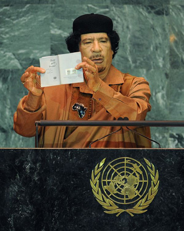 Muammar Gaddafi holds up a document during his speech to the UN general assembly