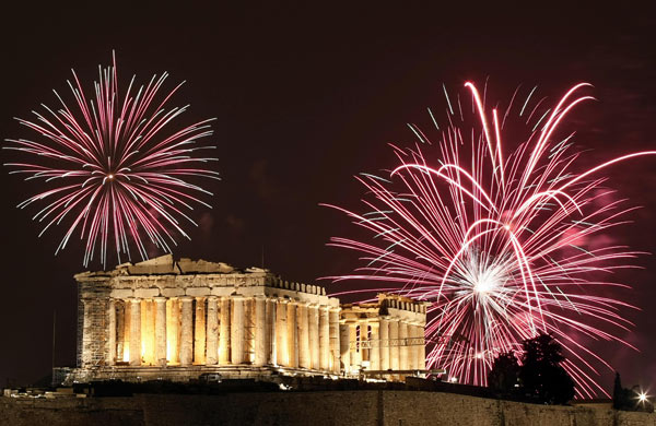 Fireworks burst over the ancient temple of Parthenon at the Acropolis hill in Athens