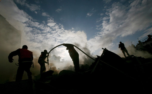 Gallery gaza pm updated: Palestinian firemen operate at the destroyed house