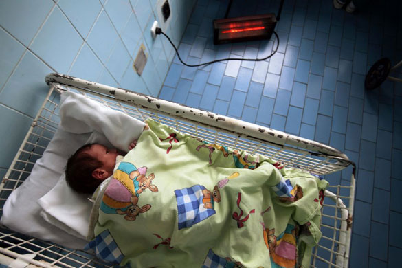 Gallery 11 January 2009: A new born baby sleeps next to an electric heater in Sofia