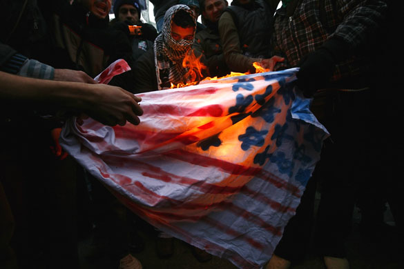 Gallery Gaza protests: 10 January: Protesters burn a US flag during a demonstration in Athens