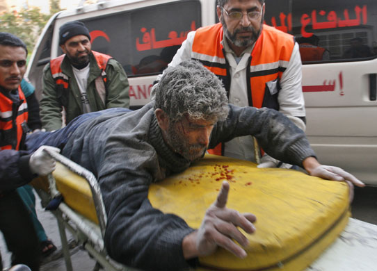 Gallery Gaza: Medics wheel a wounded man to Kamal Adwan hospital  in Gaza