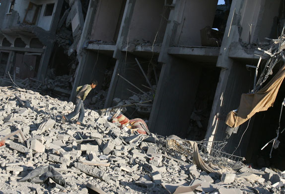 Gallery Gaza: A Palestinian boy walks ina building destroyed by Israeli strikes 