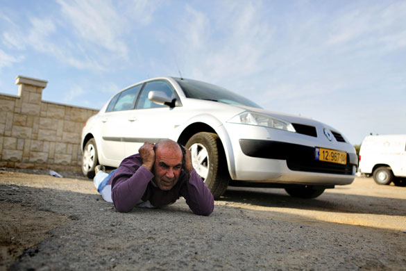 Gallery Gaza conflict continues: Israeli man takes cover next to car in Ashkelon